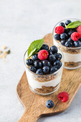 Granola with yogurt, blueberries and raspberries. Healthy breakfast. Menu, recipe.