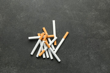 Many cigarettes on dark background