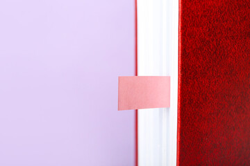 Book with bookmark on color background, closeup