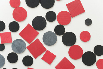 painted black and red shapes on a light background 