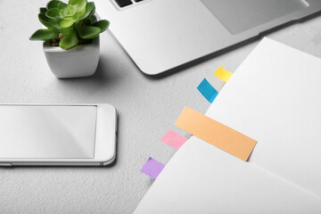 Composition with bookmarks and modern gadgets on light background