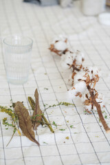 Cotton flowers next to the glass