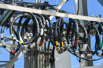 A roll of fiber-optic cables hanging from a pole. Optical fiber cable of high speed internet...