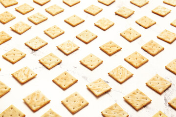 Tasty crackers on light background