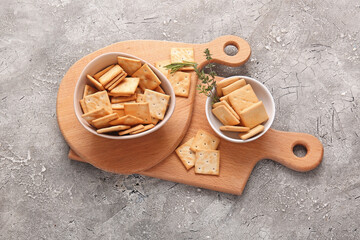 Composition with tasty crackers on grunge background