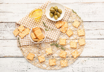 Composition with tasty crackers on light wooden background