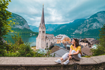 woman sitting and enjoying the vie of hallstatt austria