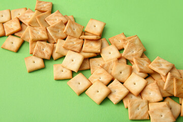 Tasty crackers on color background, closeup