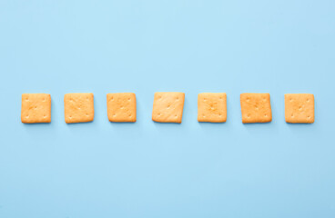 Tasty crackers on color background