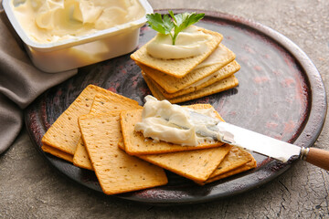 Tasty crackers with cheese on grunge background, closeup