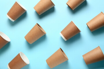 Takeaway cups for coffee on color background