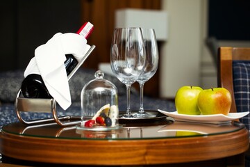 Honeymoon celebration with wine tasting and  food pairing. Luxurious bottle of wine on the wine stand and gourmet food.