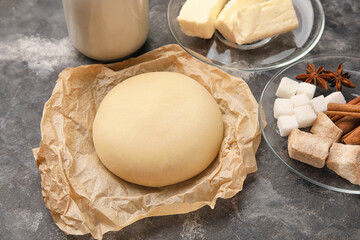 Fresh dough and ingredients on grunge background