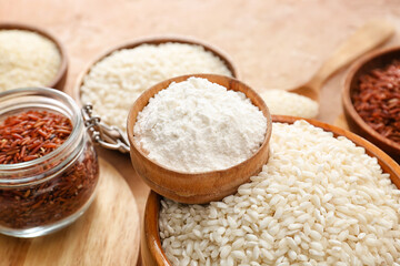 Different types of raw rice and flour on color background, closeup