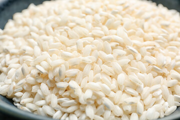 Bowl with raw rice, closeup