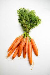 A bunch of carrots with tops, isolated on a white background