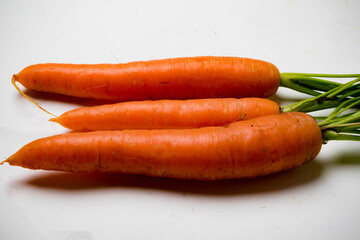 A bunch of carrots with tops, isolated on a white background