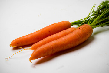 A bunch of carrots with tops, isolated on a white background