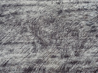 An old wooden plank table with a mottled surface and a pattern.