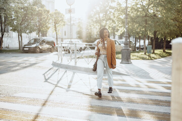 Young african american woman crossing the street