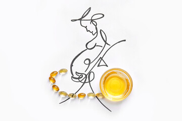 Bowl of fish oil, capsules and drawn pregnant woman on white background