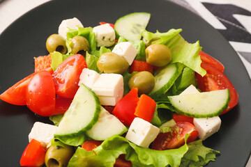 Plate with fresh Greek salad on table, closeup