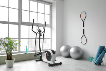 Different sports equipment and fitness balls in gym