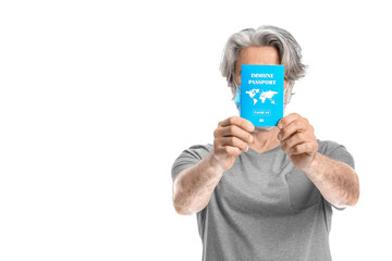 Senior man with immune passport on white background