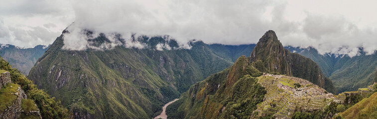 Fototapeta premium Panoramic view of Machu Picchu lost city with Huayna Picchu mountain. Ruins of ancient inca civilization in the sacred valley of Cusco Province. Peru, South America