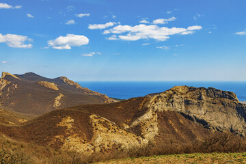 Mountains landscape against blue sky with clouds on sunny day