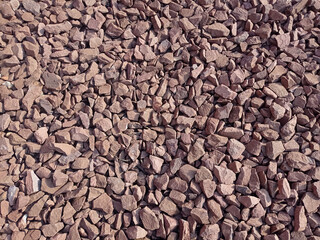 Texture crushed stone with a red hue in the side light