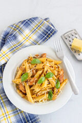 Chicken Penne Pasta Garnish with Basil Leaves Top Down Vertical Photo