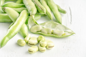 closeup fresh broad beans on a wooden table