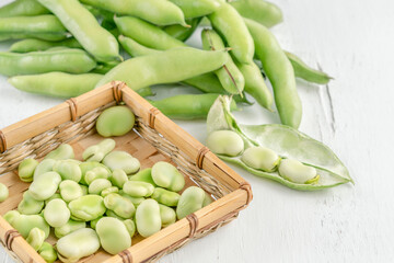 closeup fresh broad bean seeds on a wooden table