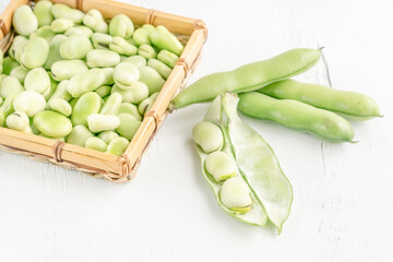 closeup fresh broad bean seeds on a wooden table