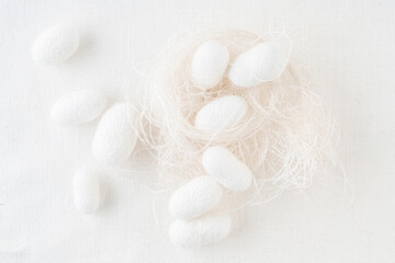 background with silk cocoons, commercially bred caterpillar of silkworm moth
