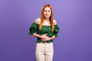Photo of upset sad young woman dressed off-shoulders blouse stomach ache isolated violet color...