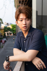 Young Asian man hair style men in navy blue shirt casual portrait.	