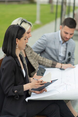 Three business people are looking at the planogram