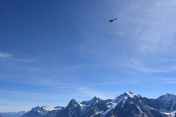 Fototapeta na wymiar Helicopter over swiss alps