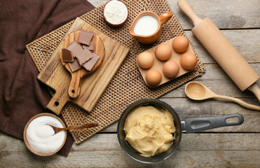 Fototapeta na wymiar Ingredients for preparing churros on wooden background