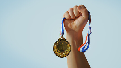 woman hand raised, holding gold medal against sky. award and victory concept - obrazy, fototapety, plakaty