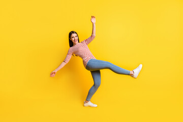 Fototapeta na wymiar Full length body size view of attractive cheerful girl dancing fooling having fun isolated over bright yellow color background