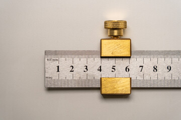 Close up of a carpenters  builders brass and stainless steel measuring and marking rule gauge
