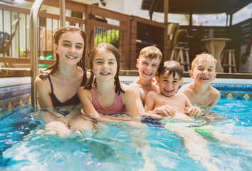 Fototapeta premium group of children having fun in Pool on the summer time