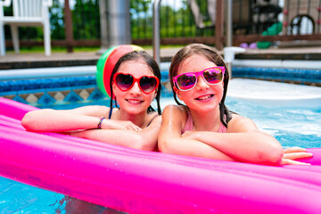 two sister having fun in Pool on the summer time