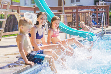 group of children having fun in Pool on the summer time