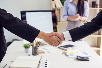Business people shaking hands success agreement at the office.