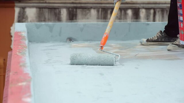 Hand painted gray flooring with paint rollers for waterproof, reinforcing net,Repairing waterproofing deck flooring.	