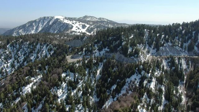 Winter Snow Forest Aerial Shot of San Bernardino Mountains Ski Trails Descend California USA